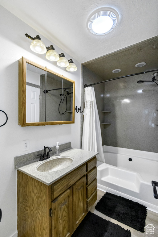 Bathroom with vanity and shower / bath combo