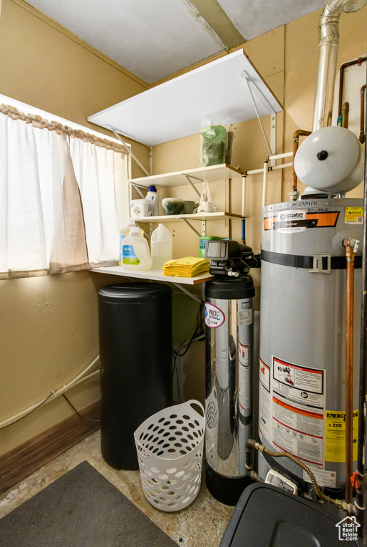 Utility room featuring secured water heater