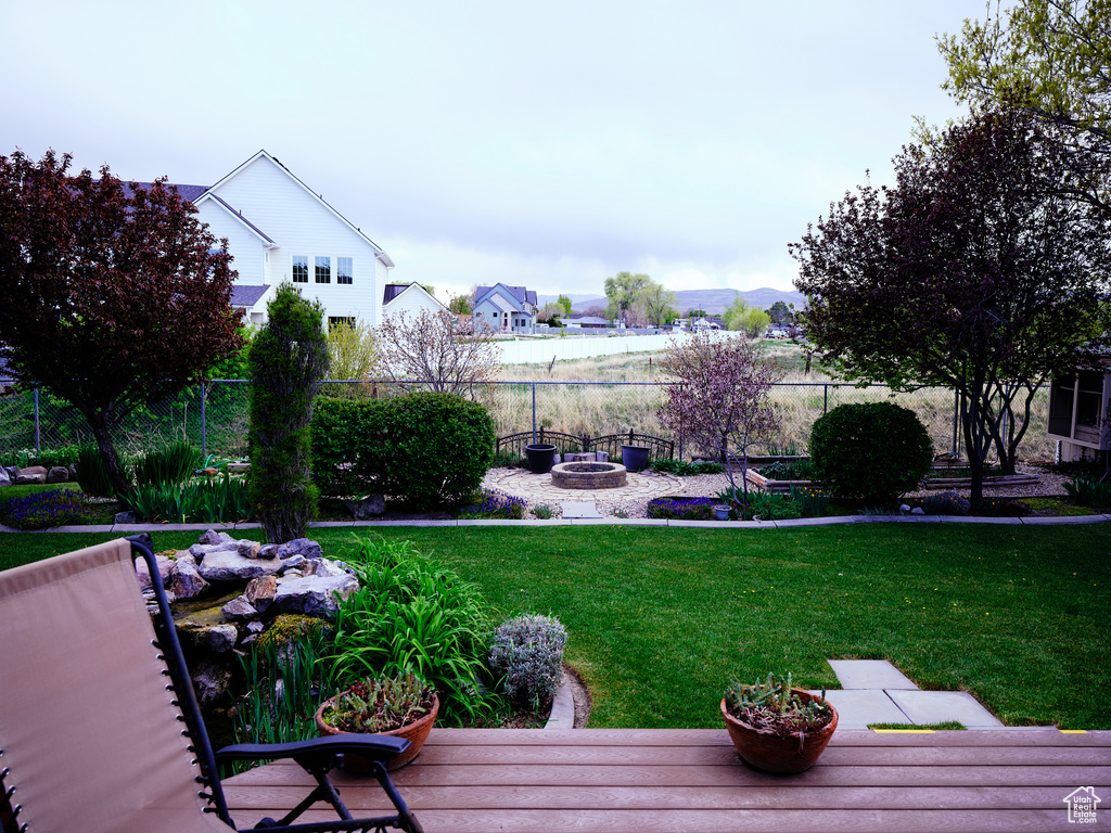 View of yard featuring fence and a fire pit