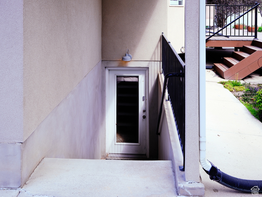 Property entrance featuring stucco siding