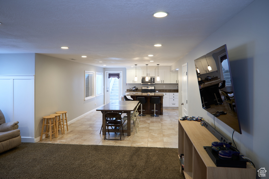 Dining area with recessed lighting, baseboards, and light tile patterned flooring