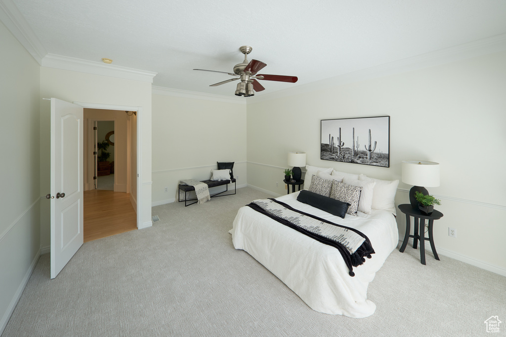 Bedroom with carpet floors, ornamental molding, baseboards, and a ceiling fan