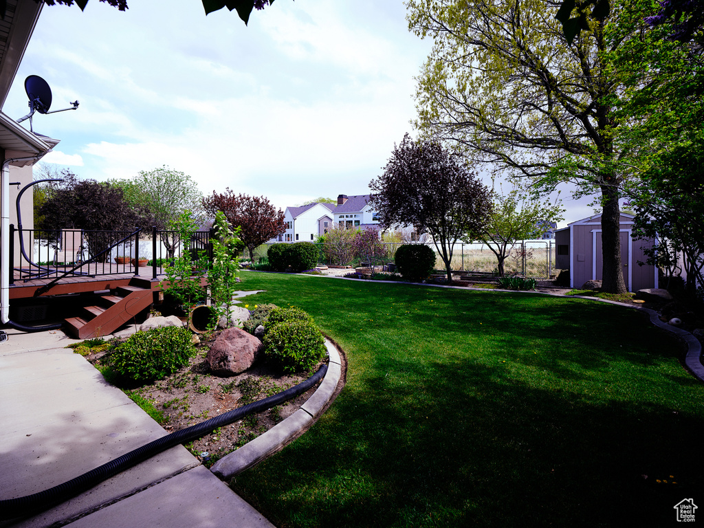 View of yard with an outbuilding and a storage shed