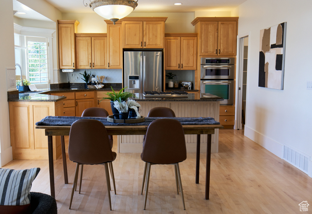 Kitchen featuring visible vents, a kitchen island, recessed lighting, light wood-style flooring, and stainless steel appliances