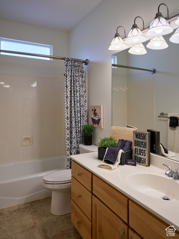 Bathroom featuring vanity, tile patterned floors, toilet, and shower / tub combo