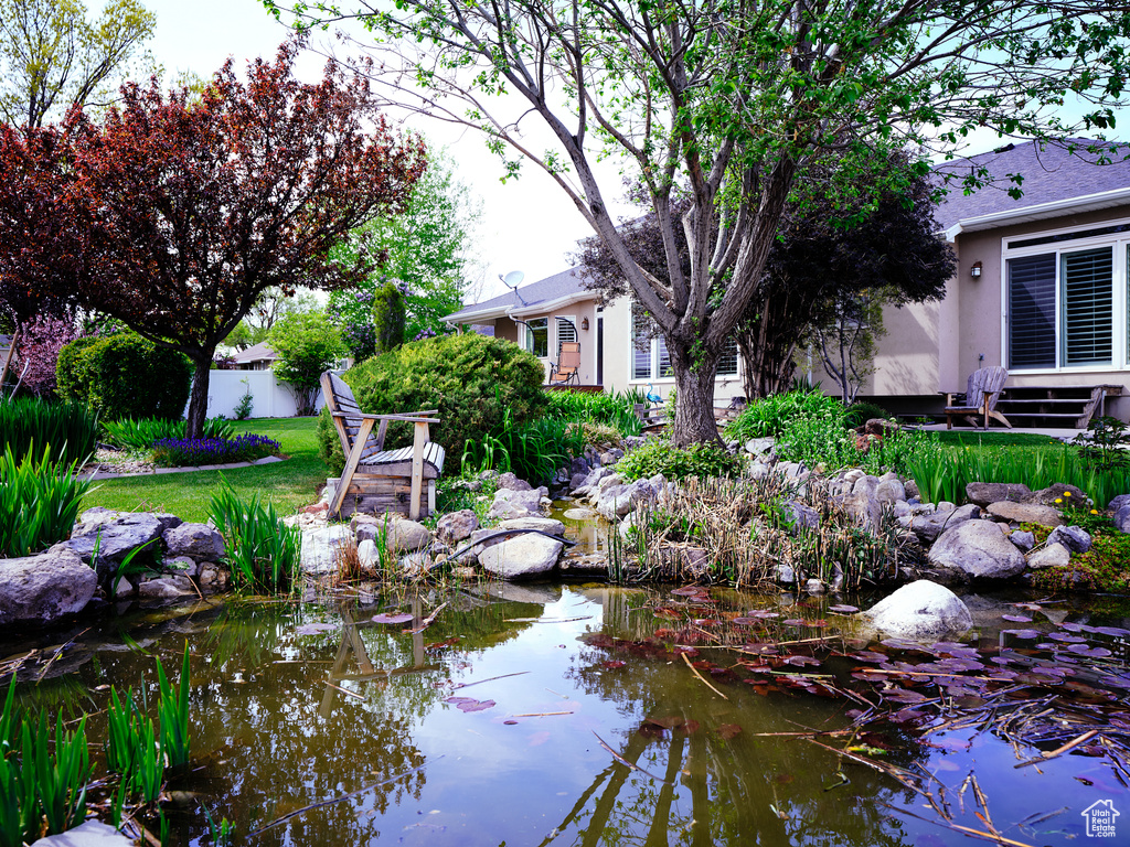 View of community featuring a small pond