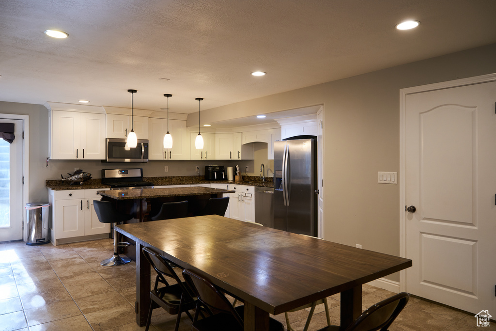 Dining room with recessed lighting and light tile patterned flooring
