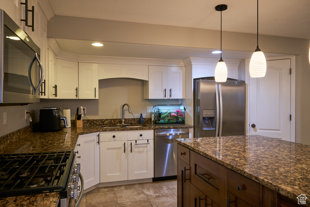 Kitchen with a sink, white cabinets, stainless steel appliances, and recessed lighting