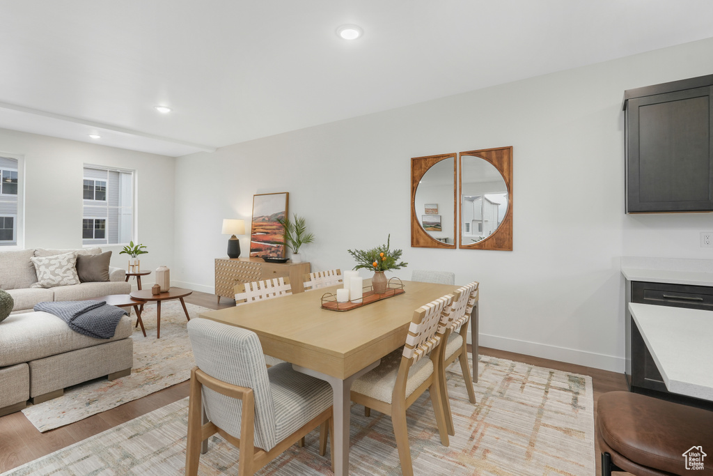 Dining room featuring baseboards, light wood-type flooring, and recessed lighting