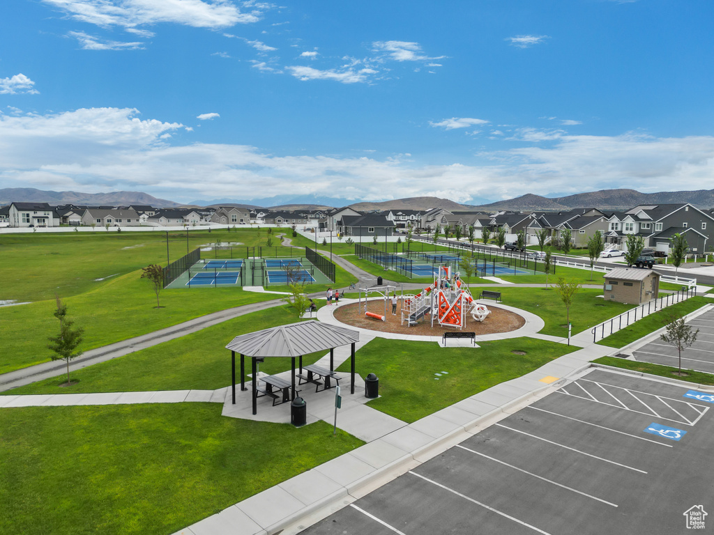 View of home's community featuring a gazebo, a residential view, a lawn, and uncovered parking
