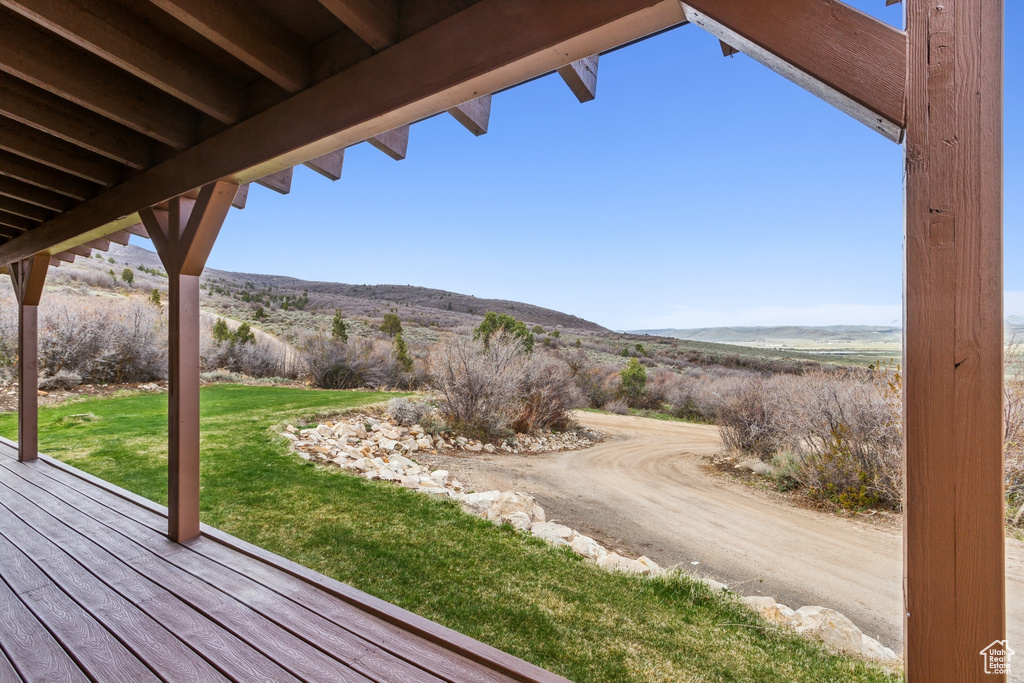Deck with a lawn and a mountain view