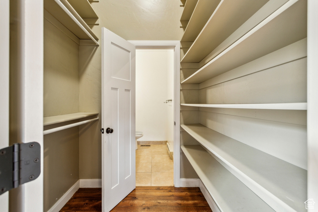Spacious closet featuring wood finished floors