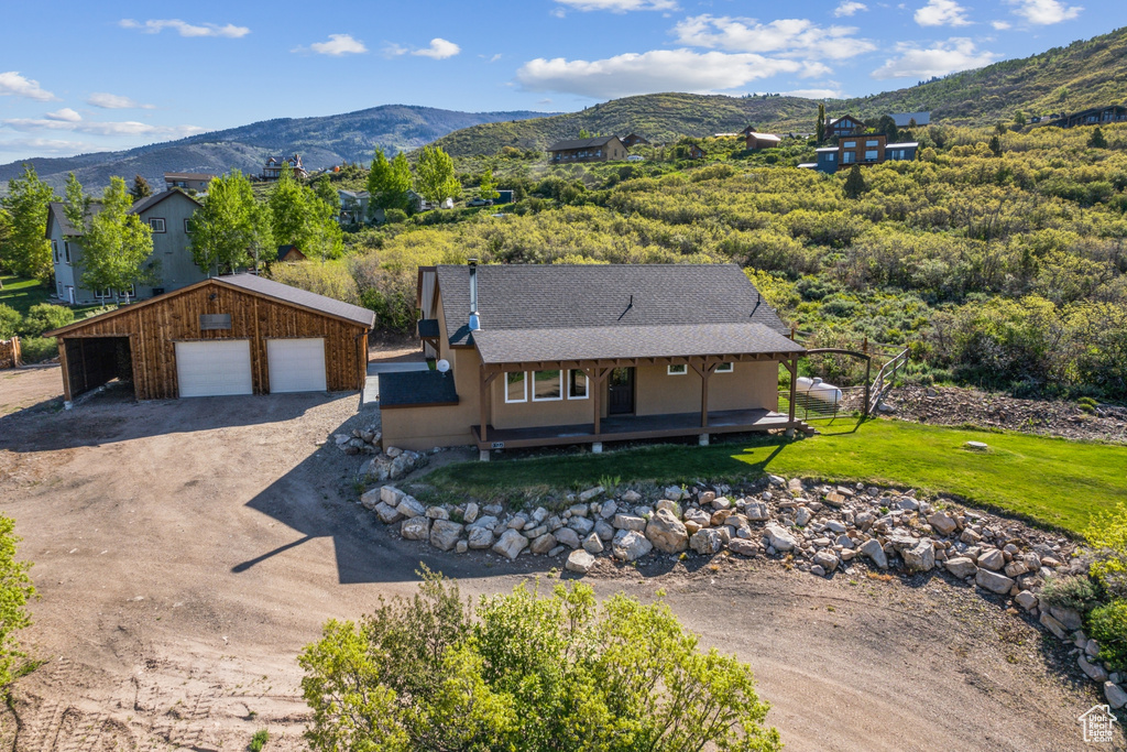 Aerial view of property and surrounding area with a mountain backdrop