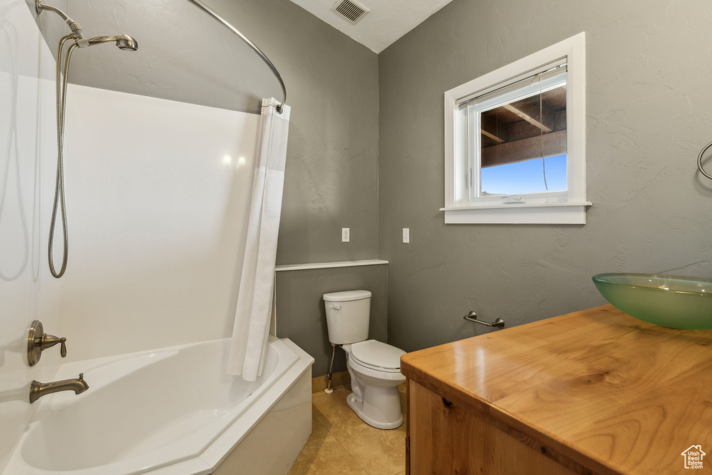 Full bathroom with visible vents, tile patterned flooring, vanity, toilet, and shower / bathtub combination with curtain