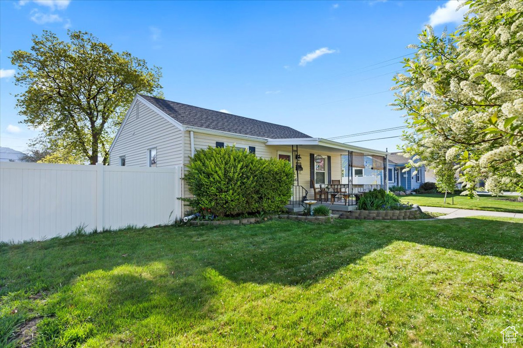 Single story home with fence and a front lawn