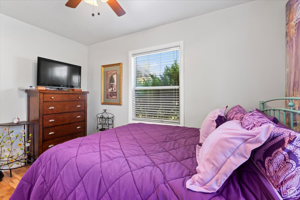 Bedroom with wood finished floors and a ceiling fan