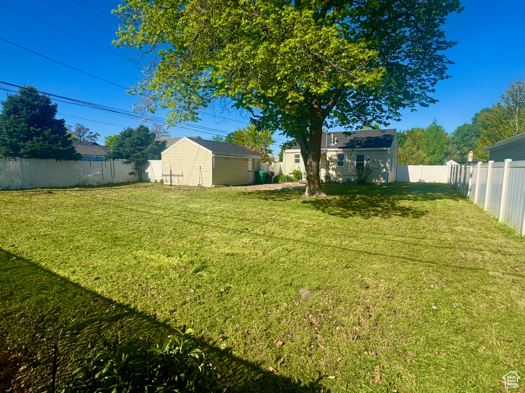 View of yard featuring an outdoor structure and a fenced backyard