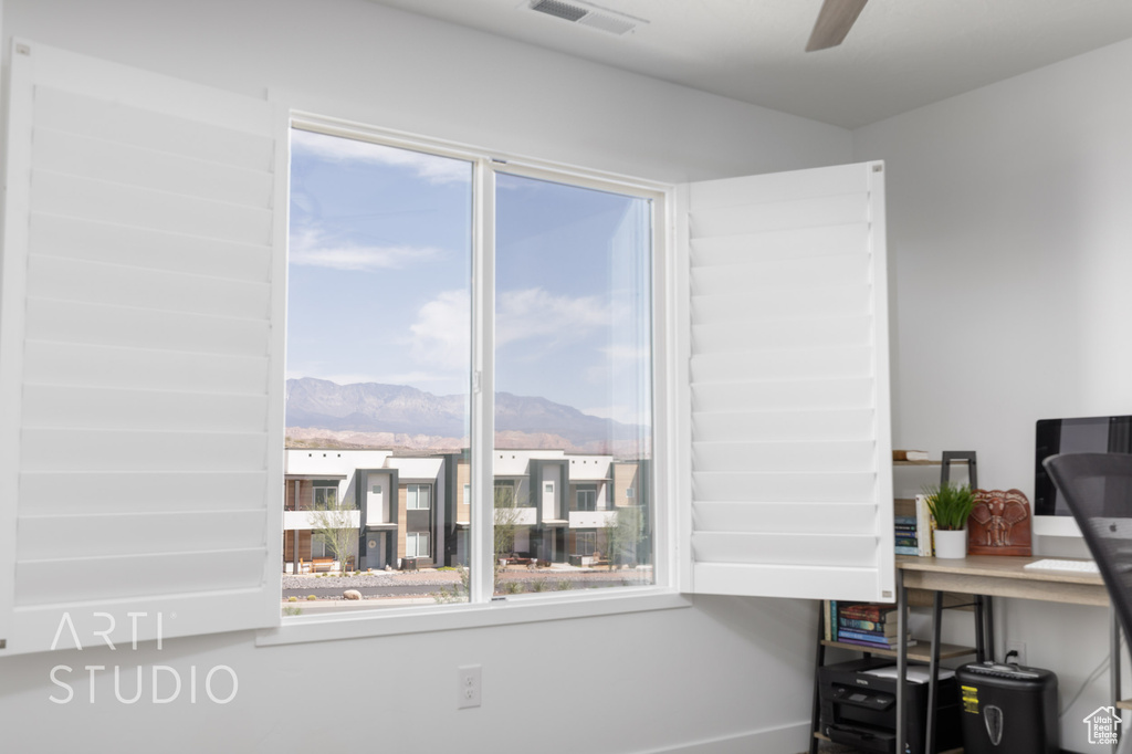 Interior space with a mountain view, visible vents, and a ceiling fan