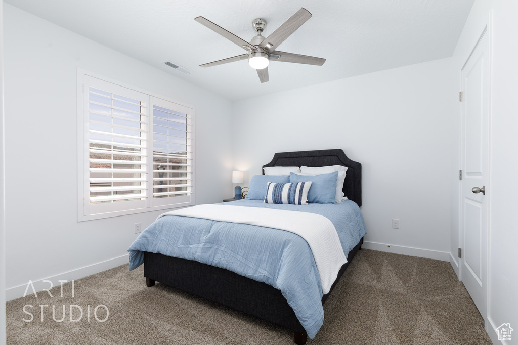 Bedroom with visible vents, ceiling fan, carpet floors, and baseboards