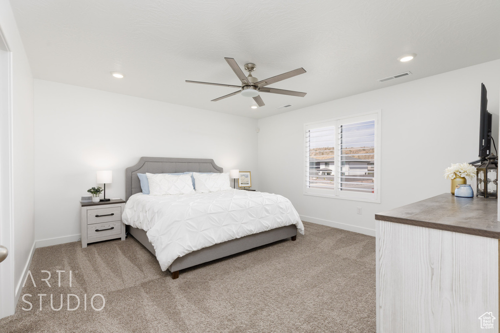 Bedroom featuring light colored carpet, visible vents, recessed lighting, and baseboards