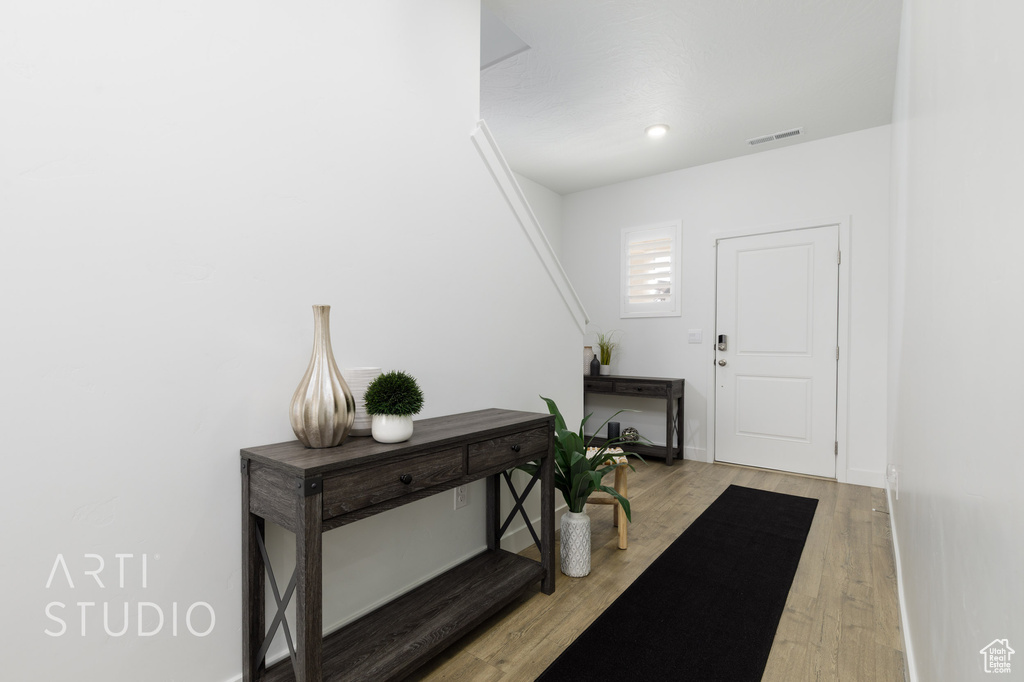 Entryway with baseboards, visible vents, light wood-type flooring, and recessed lighting