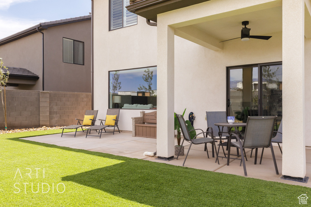View of patio / terrace with fence and ceiling fan
