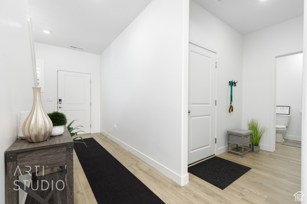 Entryway with light wood-style floors, recessed lighting, visible vents, and baseboards