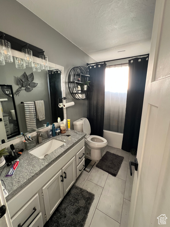 Full bathroom with a bath, a textured ceiling, vanity, toilet, and a shower with shower curtain