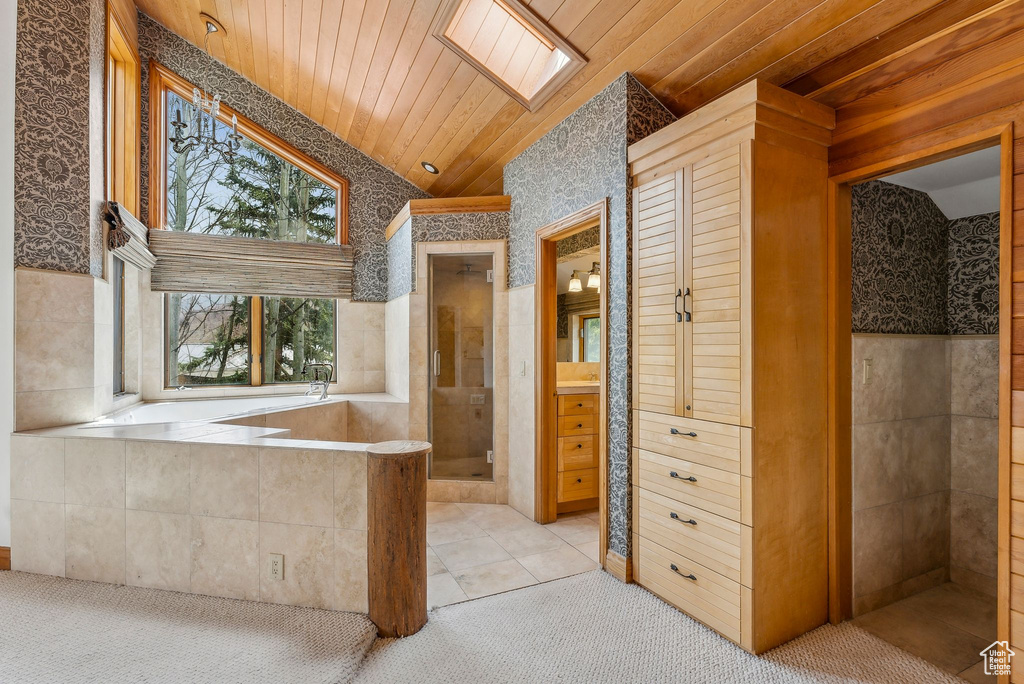 Bathroom with vaulted ceiling, wallpapered walls, a stall shower, and wooden ceiling