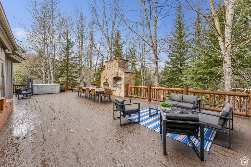 Wooden deck with an outdoor living space with a fireplace