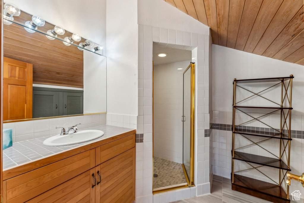 Full bathroom with a shower stall, wooden ceiling, recessed lighting, vaulted ceiling, and vanity