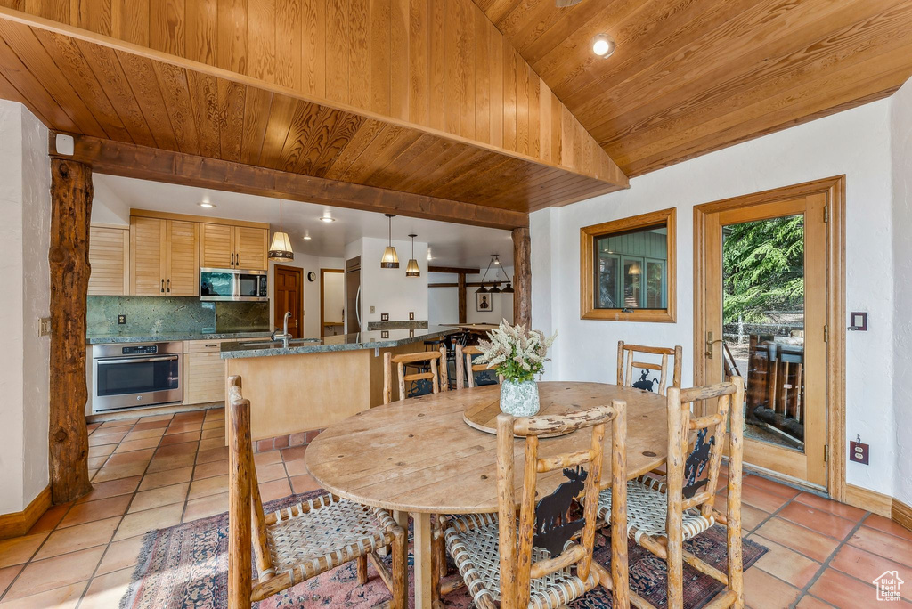 Dining room featuring wood ceiling, light tile patterned floors, baseboards, recessed lighting, and vaulted ceiling