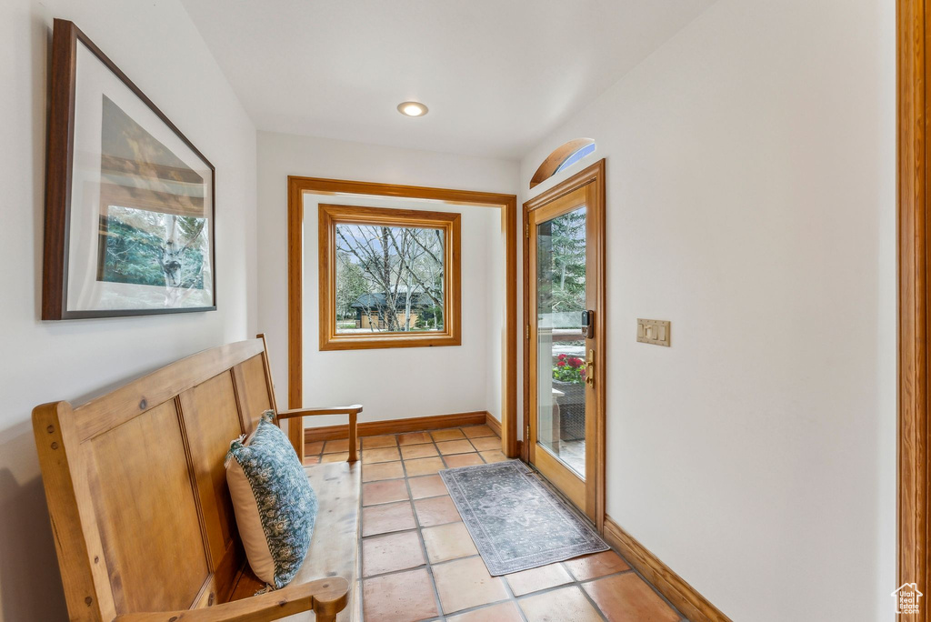 Entryway featuring baseboards, recessed lighting, and light tile patterned floors