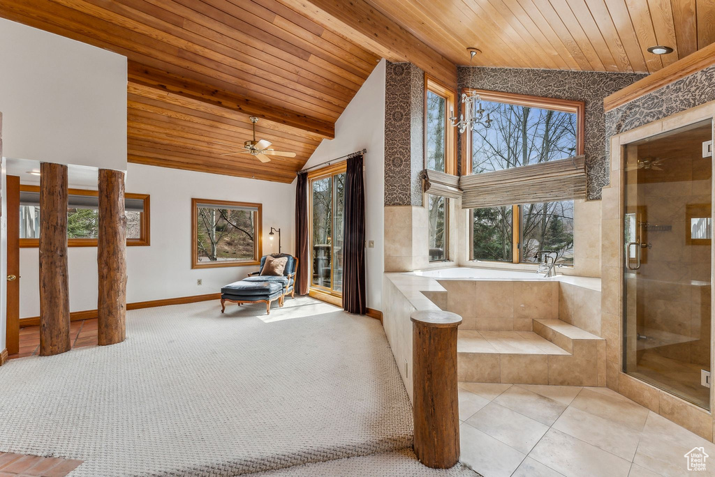 Full bathroom featuring baseboards, wooden ceiling, a wealth of natural light, and a bath
