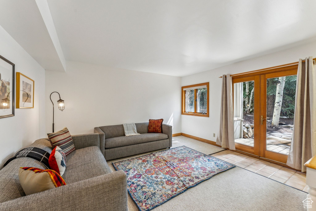 Living area featuring tile patterned floors, french doors, and baseboards