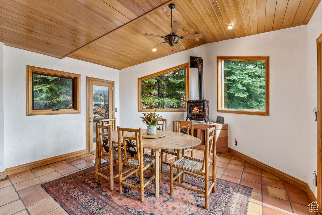 Tiled dining space with baseboards, wooden ceiling, ceiling fan, and vaulted ceiling
