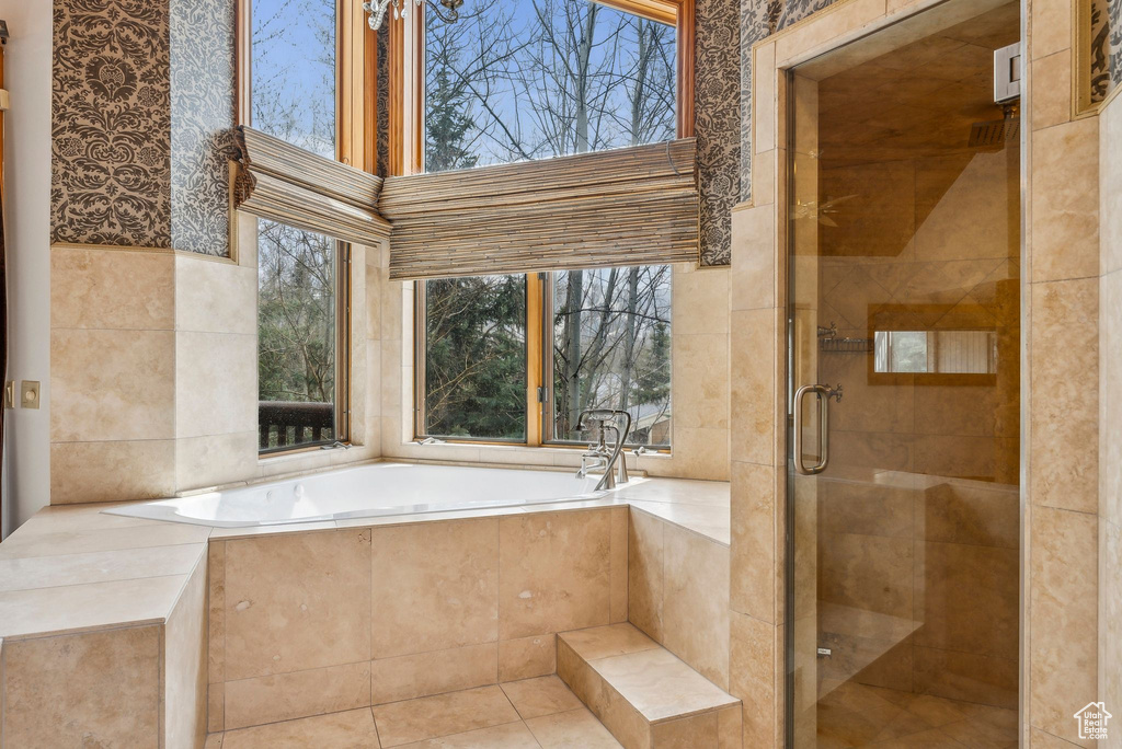 Full bathroom featuring a shower stall and a garden tub