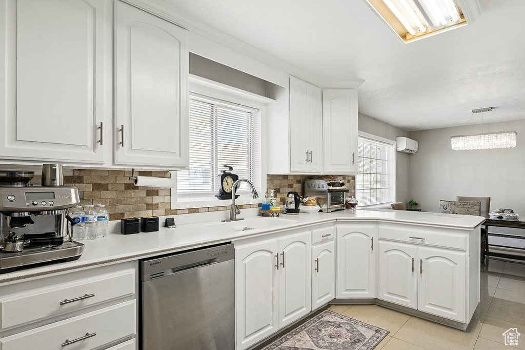 Kitchen with an AC wall unit, a sink, decorative backsplash, light tile patterned flooring, and dishwasher
