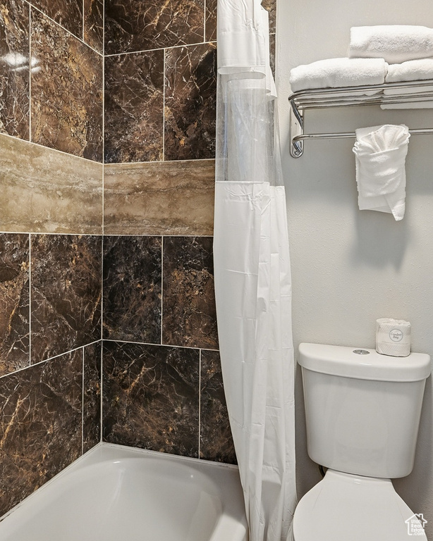 Full bathroom with shower / tub combo and toilet
