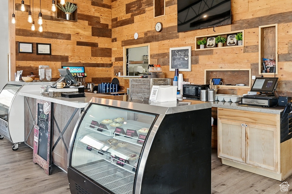 Interior space with light wood-type flooring and wooden walls