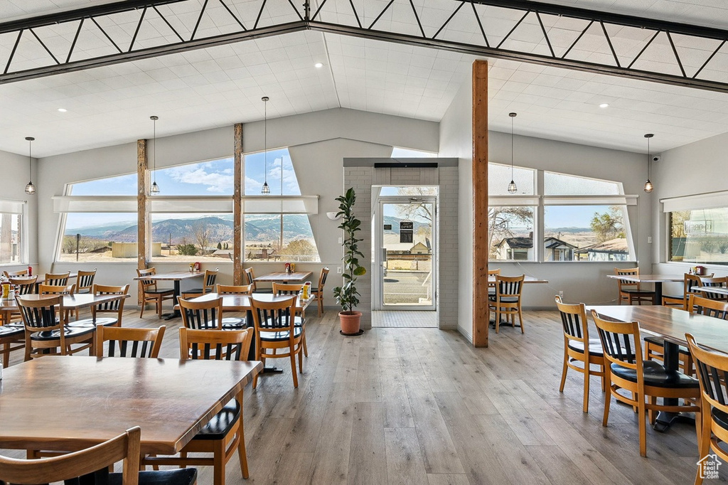 Dining room with recessed lighting, wood finished floors, and a healthy amount of sunlight