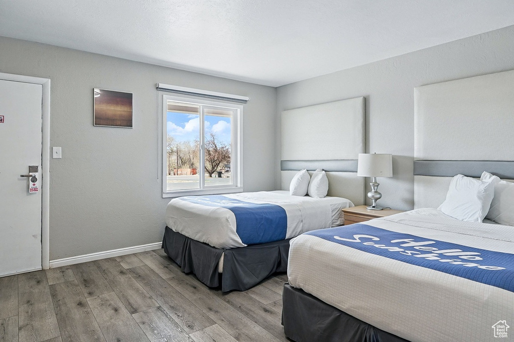 Bedroom with baseboards and wood finished floors