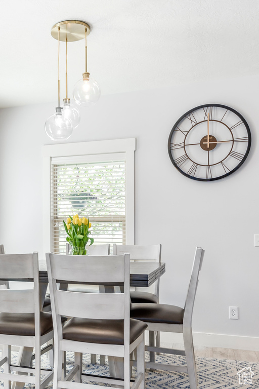 Dining area featuring light tile patterned flooring and baseboards