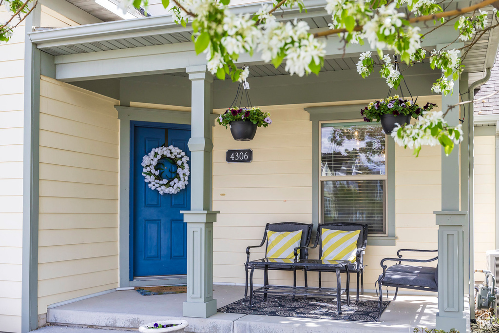 View of exterior entry featuring covered porch