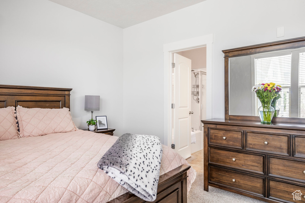 Bedroom featuring light carpet