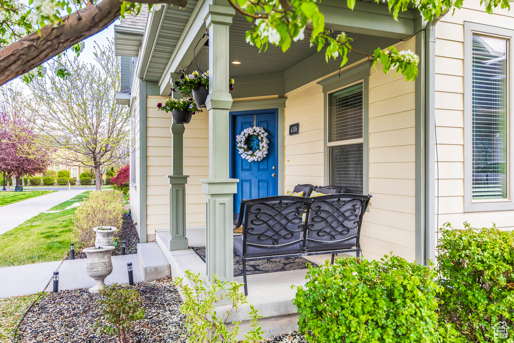 Doorway to property featuring covered porch