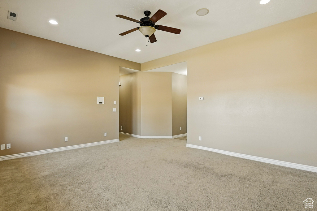 Unfurnished room featuring recessed lighting, ceiling fan, light carpet, and baseboards