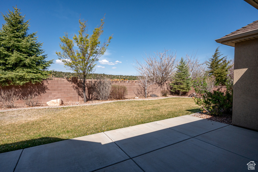 View of yard featuring fence and a patio area