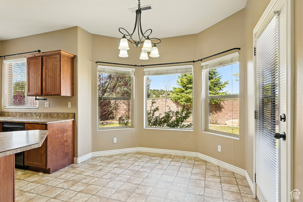 Interior space featuring plenty of natural light, stone tile flooring, and visible vents