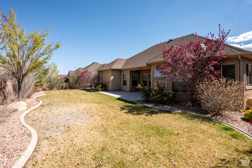 View of yard with a fenced backyard and a patio
